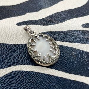 Pretty Mother of Pearl Oval Pendant Surrounded by Rhinestones Design